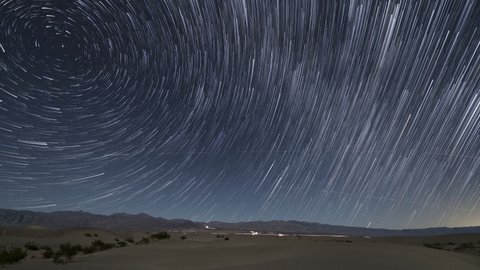 Time lapse of star trails over sand dunes in Death Valley in California