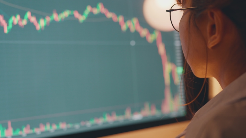 Closeup - Woman is checking Bitcoin price chart on digital exchange on computer, cryptocurrency future price action prediction. Royalty-Free Stock Footage #1072512992