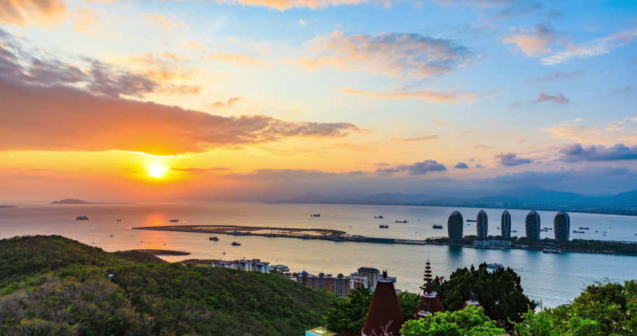 Famous modern city skyline and buildings with sea in Sanya at sunset,Hainan,China.