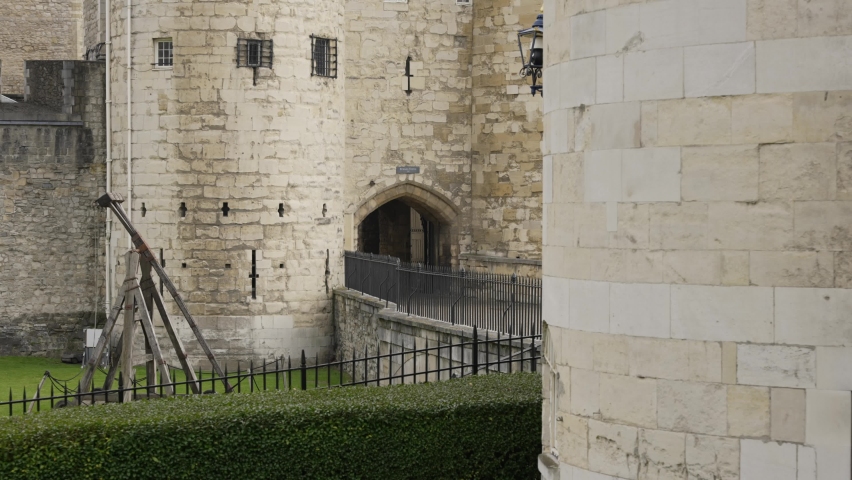 Entrance of an English medieval castle with a catapult, London, UK
