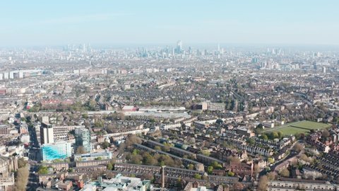 Descending drone shot of London skyline from highgate sunny day