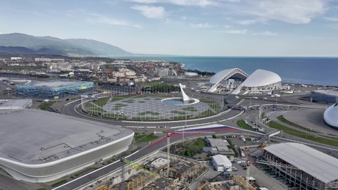 Sochi, Russia - 2021: Olympic flame, flags and Fisht football stadium from above. Aerial view. Sochi, Russia. 