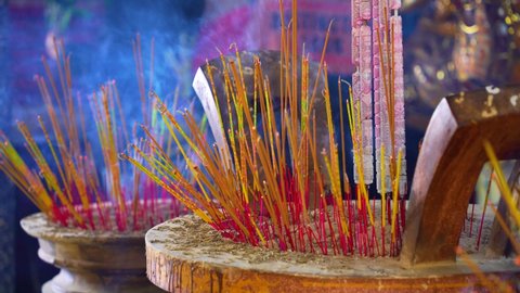 Buddhist temple and incense sticks (joss sticks) burning for praying in Ho Chi Minh city, Vietnam. Selective focus.