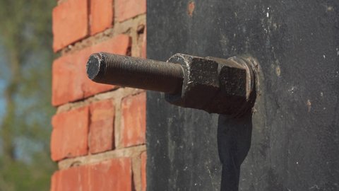Large metal bolt securing brickwork from subsiding