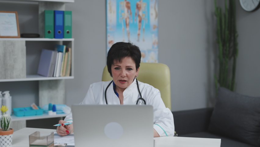 Female doctor making online video call consulting patient. European woman therapist talking to camera in remote chat. Telemedicine, telehealth. Modern medecine concept.