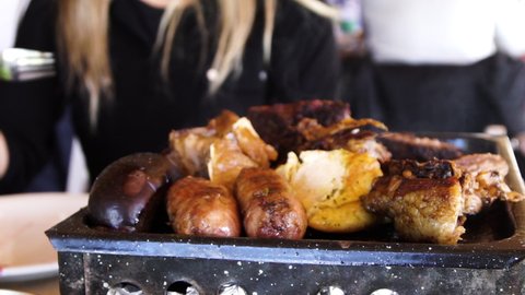 Typical barbecue with meat, sausage, and blood sausage in Argentina, close up