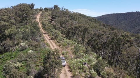 High Drone shot of 4WD Toyota Driving up a Mountain in the bush, Near Lake Eildon Victoria Australia