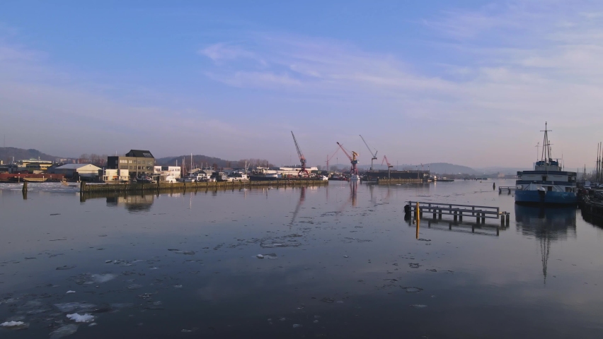 Gota Alv River With Harbour Cranes And Buildings In The Background In Gothenburg, Sweden. - aerial