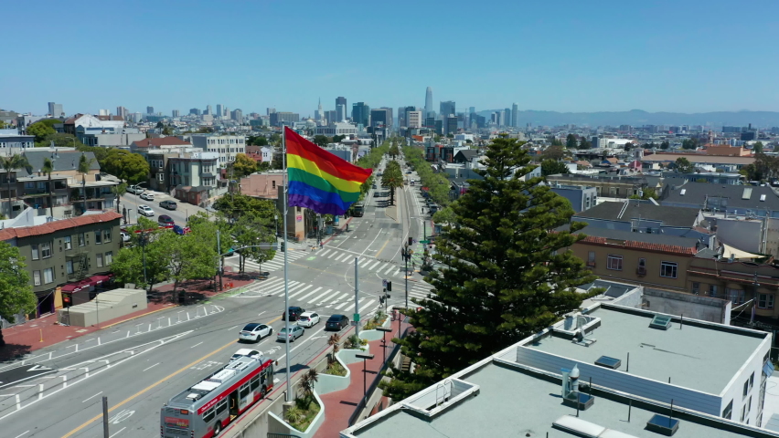 Flying past gay pride flag in The Castro towards San Francisco skyline