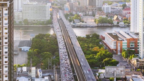 Bangkok traffic toward downtown during rush hour on Taksin bridge over Chao Phraya river in morning - time lapse
