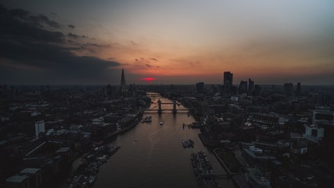 Hyperlapse Time Lapse, dark moody red sunset, Establishing Aerial View Shot of London UK, United Kingdom