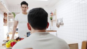 Asia gay couple blogger vlogger and online influencer recording video content on healthy food in kitchen at home. Young LGBT men talk happy relax rest together spend romantic time at house in morning.
