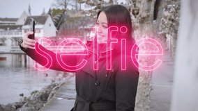 Young female model taking selfies on vacation in small wintry town on the bank of a river. Digital selfie text overlay. - Powered by Shutterstock - Get 15% off with code: PIKWIZARD15