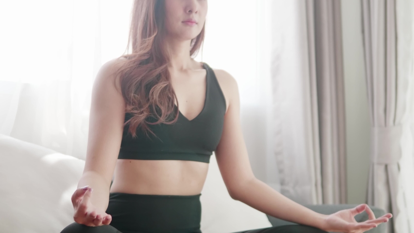 Young Asian women lovey with yoga exercise and stretching in the living room