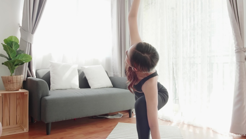 Sport women lovey with yoga exercise and stretching in the living room at home