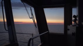 Silhouette of a male navigational officer entering bridge on a ship at sunset - Powered by Shutterstock - Get 15% off with code: PIKWIZARD15