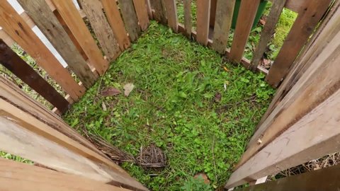 Composting bin with organic food waste and organic materials. Compost making, filling compost. Recycling concept. Timelapse