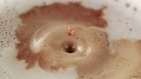 Super slow motion of falling drop into coffee. Filmed on high speed cinema camera, 1000fps.