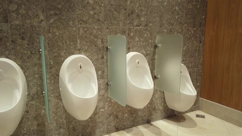 Fragment of the interior of the men's room. Urinals on the walls.