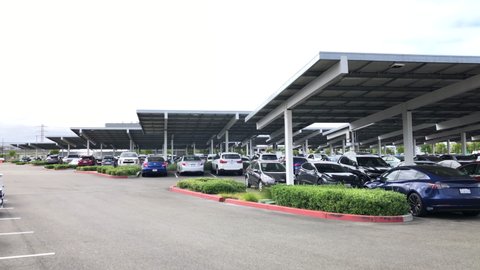 San Leandro, CA - May 17, 2021: Solar panels cover parking spaces in the Kaiser hospital parking lot, producing reduced energy consumption and electrical costs. shaded, cooler and more comfortable car