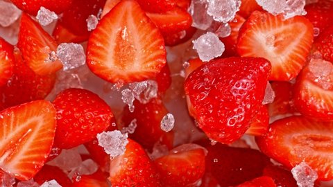 Super Slow Motion Shot of Fresh Strawberries and Crushed Ice Flying Towards Camera at 1000fps.