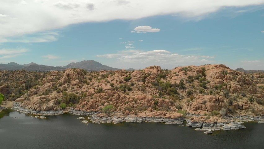 Panoramic view of Watson Lake on sunny day overlooking the lake, granite dells, kayakers and park with beautiful landscape