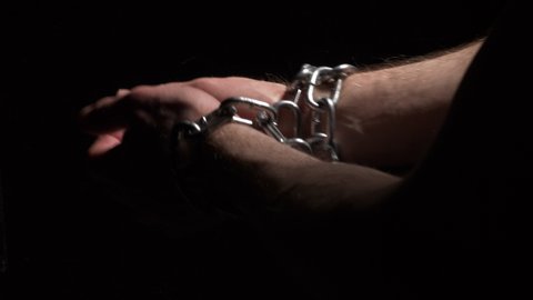 Conceptual shot of hands breaking loose from chains