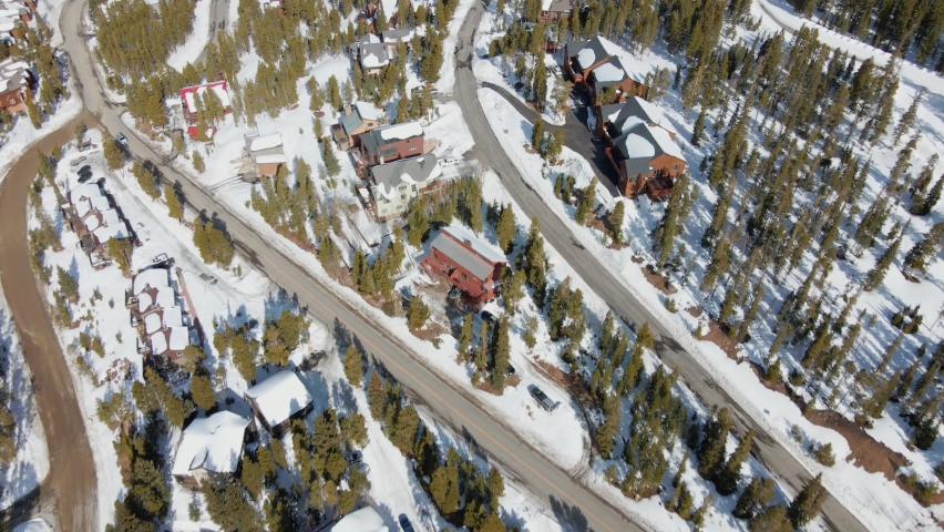Aerial drone view overlooking cabins and houses in Breckenridge, sunny Colorado