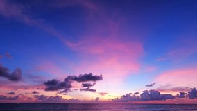 Colorful red purple pink sunset cloud n evening dark grey cloudscape on beautiful twilight sky background over deep blue sea water surface n calm ocean wave ripple, Slow Motion 4k b-roll footage video - Powered by Shutterstock - Get 15% off with code: PIKWIZARD15