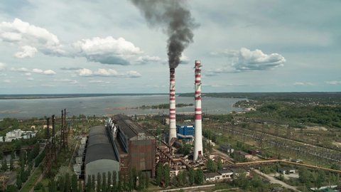 Aerial view of old coal power plant with black smoke from chimneys. Ecology and greenhouse effect.