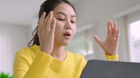 Young asian woman employee work from home using computer notebook videocall meeting conference angry annoy with low poor unreliable internet wifi connection problem issue outage.