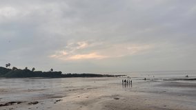 time lapse of a beach view with a scenic stormy clouds during monsoon season in Mumbai city with a beautiful color shades, people enjoying holidays on beach time lapse view abstract video background