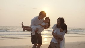 Silhouetted happy asian family playing and having fun on the beach at sunset. Freedom, Relationship, embrace and Travel concept. Positive emotion and feeling warmwith sun flare in evening. - Powered by Shutterstock - Get 15% off with code: PIKWIZARD15
