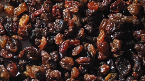 raisins. close-up. rotation food. Raisins background rotate slowly, top view. Dried fruit, light and dark raisins for healthy diet. food background. Gastronomy concept, organic food.