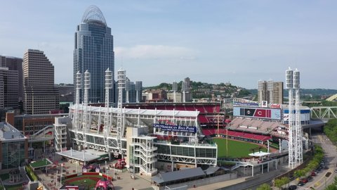 Cincinnati, Ohio, USA - May 18 2021: Aerial drone shot of the Great American Ball Park and Cincinnati skyline. Pedestal lift up with Mt. Adams in the background. 