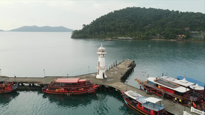 Beautiful aerial view of white lighthouse at the end of Bang Bao Pier in Ko Chang District, Trat. | Shutterstock HD Video #1072636355