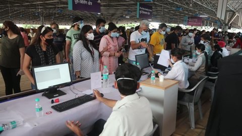 New Delhi, India, May 19, 2021: Indian people wearing face mask stands in a queue for registration to get the coronavirus (Covid-19) vaccine dose at the vaccination center in the private hospital.