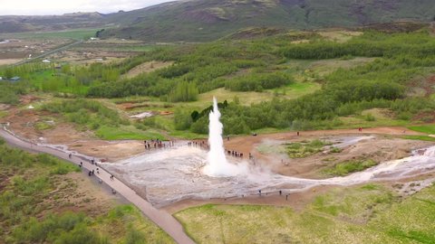  Flying over Strokkur geysir during eruption of water, Iceland, 4k aerial drone view