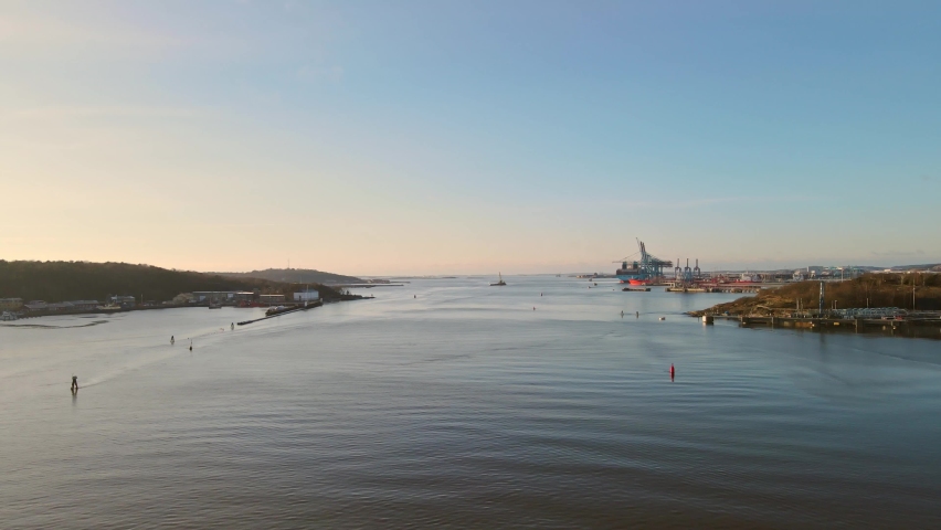 Sea Marks On Gota Alv River With Freight Ship On Harbour At Sunrise In Gothenburg, Sweden. - aerial