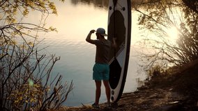 Surfer Standing With Sup Board On Vacation.Tourist On Standup Paddle Board.Strong Man Swim Surfing Boat Fitness Workout With Oar.Travel Water Tourism Holiday Vacation.Sport Recreation Sup Fun Rowing - Powered by Shutterstock - Get 15% off with code: PIKWIZARD15