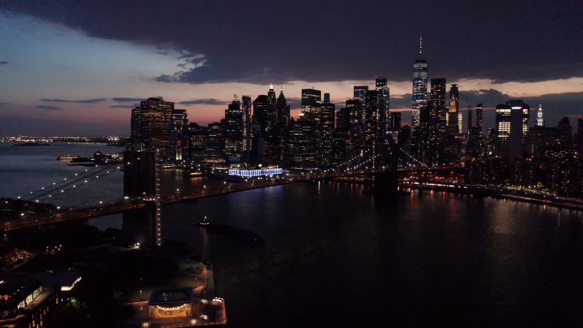 evening view of downtown NYC flying backwards over Manhattan Bridge Royalty-Free Stock Footage #1072647305
