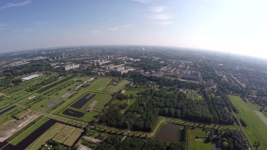 Utrecht city aerial view from the south great overview of the city crisp blue sky and green fields below center of The Netherlands Holland on of the largest towns helicopter bird eye view high sky 4k