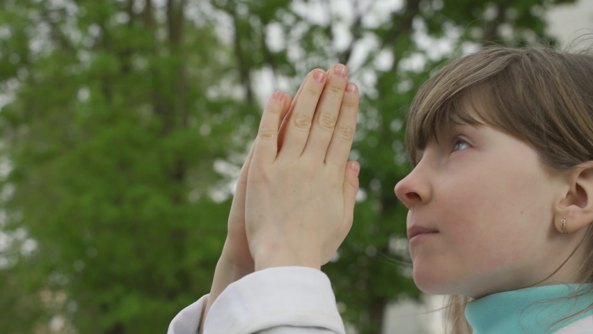 The girl asks the God of peace, love, goodness, folded his arms