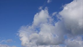 Blue sky white clouds. Puffy fluffy white clouds. Cumulus cloud scape timelapse. Summer blue sky time lapse. Dramatic majestic amazing blue sky. Soft white clouds form. Clouds time lapse background