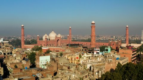 Pakistani Village With Tourists At Badshahi Mosque In Lahore City, Punjab, Pakistan. - aerial