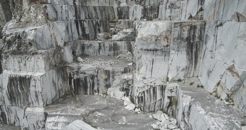 Marble texture in a quarry. Wall of a white marble quarry under the mountain. In this area there are some quarries of white marble that is extracted from the mountain with open-air quarries. 