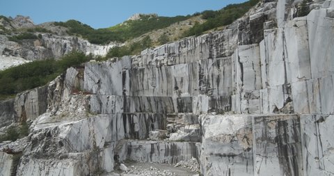 Marble quarry. Wall of a white marble quarry under the mountain. In this area there are some quarries of white marble that is extracted from the mountain with open-air quarries. 