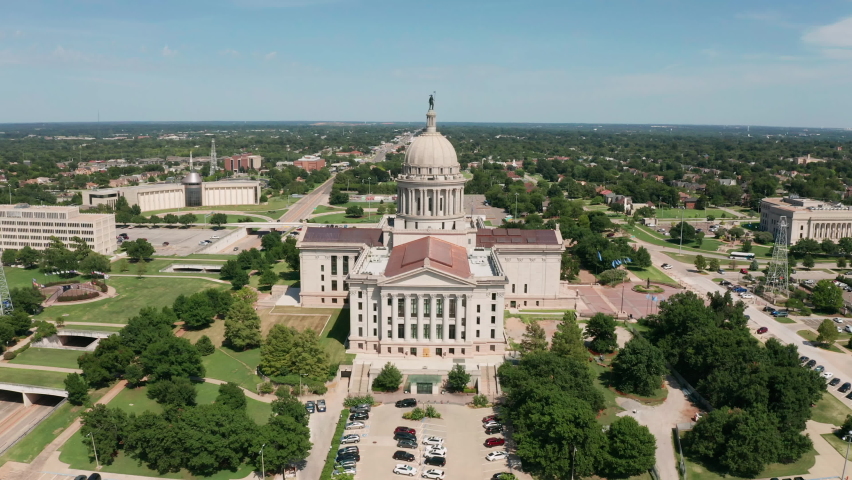 Aerial perspective flying into the urban expanse of downtown Oklahoma City United States