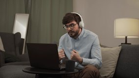a European man talks to someone in a video call.