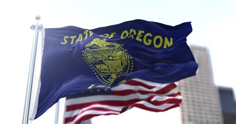 The flags of the Oregon state and United States waving in the wind. Democracy and independence. American state. Seamless 3D animation